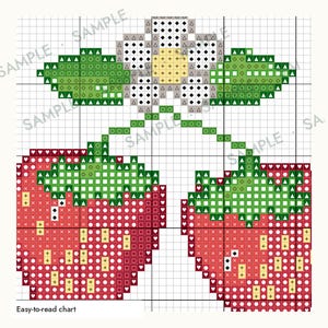 May include: A cross-stitch pattern chart featuring two red strawberries with green leaves and a white flower with a yellow center. The design is presented on a grid with symbols representing colors, and the text "Easy-to-read chart" is at the bottom.