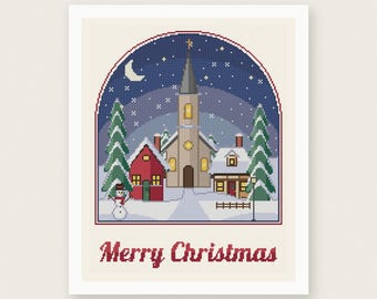 May include: A cross stitch pattern featuring a winter village scene inside an arched frame. The design includes a church, houses, pine trees, a snowman, and a night sky with a crescent moon. The text Merry Christmas is printed in red below.