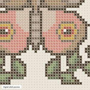 May include: A cross-stitch pattern featuring a floral design with pink, yellow, and brown petals outlined in dark brown thread. The flowers are accented with green leaves and stems, all set against a light cream-colored grid background.