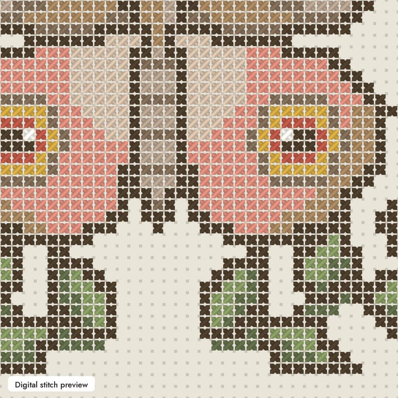 May include: A cross-stitch pattern featuring a floral design with pink, yellow, and brown petals outlined in dark brown thread. The flowers are accented with green leaves and stems, all set against a light cream-colored grid background.