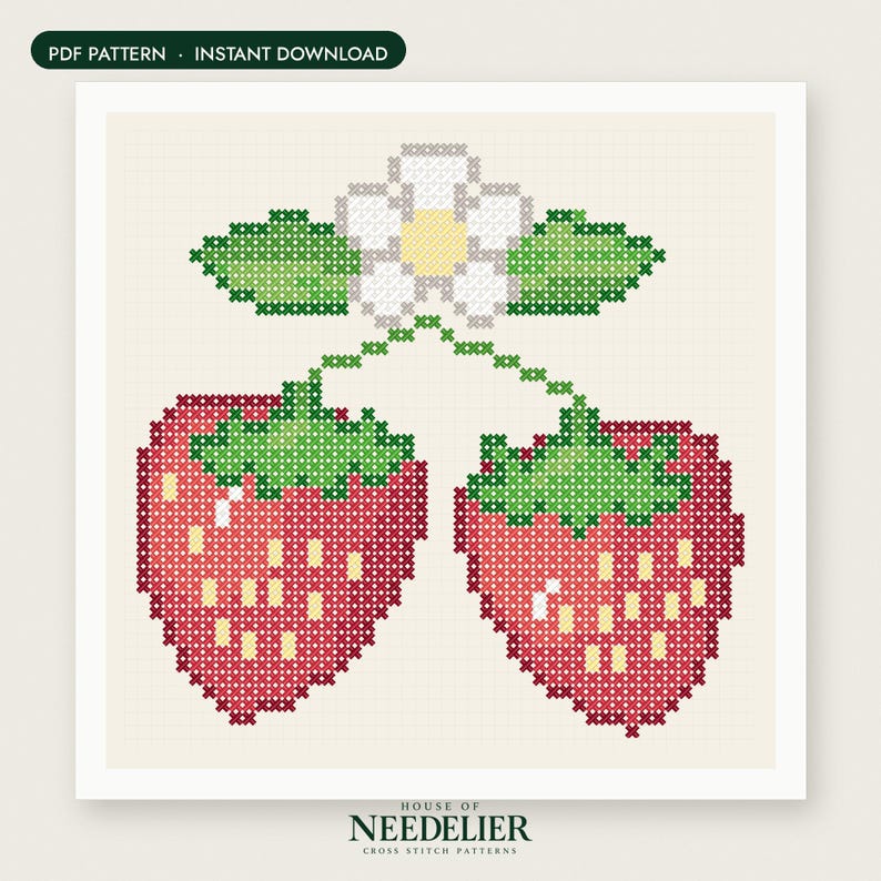 May include: A cross stitch pattern featuring two red strawberries with green leaves and a white flower with a yellow center. The design is set against a light cream grid background. The text HOUSE OF NEEDELIER CROSS STITCH PATTERNS is at the bottom.