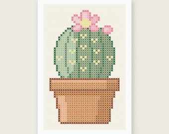 May include: A cross-stitch pattern featuring a round green cactus with small yellow heart-shaped accents and a pink flower on top, sitting in a brown terracotta pot. The image includes the text PDF PATTERN INSTANT DOWNLOAD and HOUSE OF NEEDELIER.