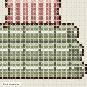 May include: A cross-stitch pattern featuring a rectangular section with a green and white plaid design and a smaller top section with vertical pink and white stripes. The entire design is outlined in dark brown stitches on a light fabric background.