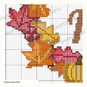 May include: A cross-stitch pattern chart featuring autumn leaves and a pumpkin, displayed on a grid with symbols. The design includes red, orange, and yellow foliage with a brown stem and a pumpkin base. The text 'Easy-to-read chart' is visible.