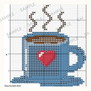 May include: A cross-stitch pattern chart featuring a blue mug with a red heart design on the front. The mug contains a brown beverage with gray steam rising from the top. The grid includes the word SAMPLE repeated across the background.