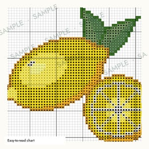 May include: A cross-stitch pattern chart featuring a whole yellow lemon with a green leaf and a sliced lemon half. The design is displayed on a white grid with black lines, incorporating various symbols like dots, triangles, and squares.