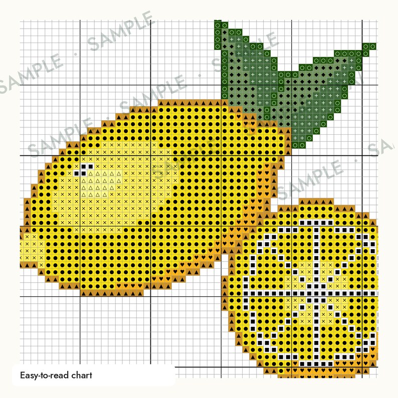 May include: A cross-stitch pattern chart featuring a whole yellow lemon with a green leaf and a sliced lemon half. The design is displayed on a white grid with black lines, incorporating various symbols like dots, triangles, and squares.