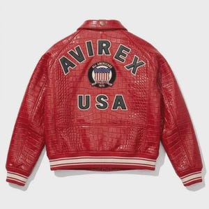 May include: A red jacket with a crocodile-embossed texture featuring the text AVIREX in black letters, a circular patch with a flag and the text ALL AMERICANS ESTABLISHED 1975, and the text USA in black letters on the back with striped trim.