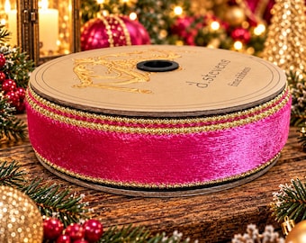 May include: A spool of vibrant hot pink velvet ribbon featuring metallic gold beaded edges. The cardboard spool is branded with the text d.stevens fine ribbons in black ink on the top surface, showcasing a textured, luxurious fabric finish.