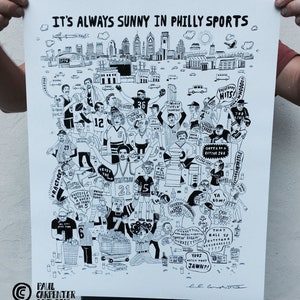May include: A black and white illustration of a cityscape with various sports figures and phrases related to Philadelphia sports. The illustration includes the Philadelphia skyline, the Liberty Bell, and the words "It's Always Sunny in Philly Sports".