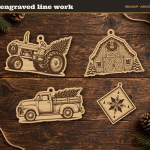 May include: Four light-coloured wooden ornaments featuring fine engraved line work. The designs include a tractor carrying a Christmas tree, a barn with a wreath, a pickup truck hauling a tree, and a diamond-shaped ornament with a star pattern.