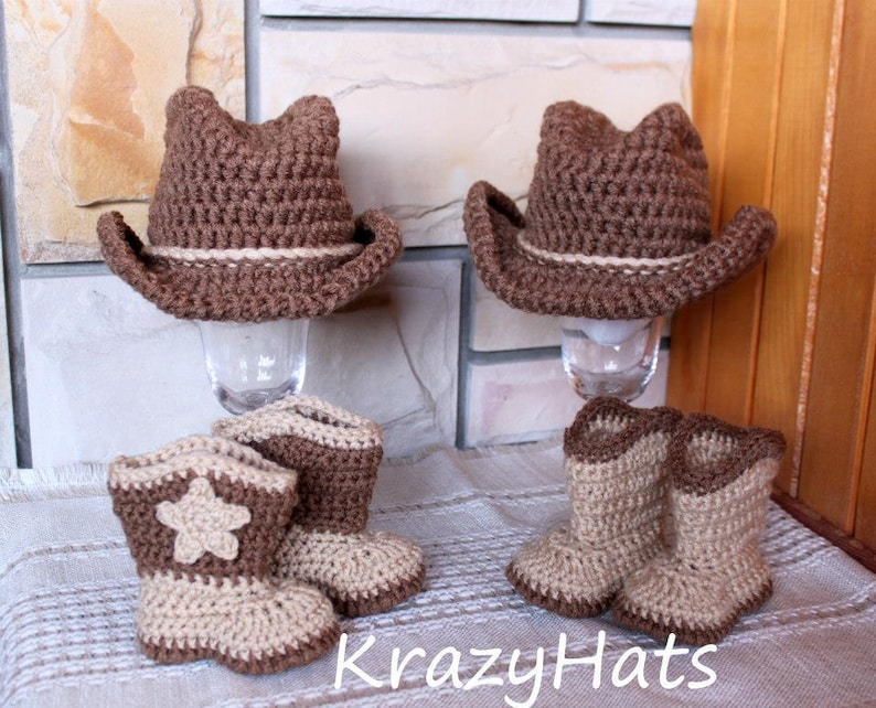 May include: Crocheted cowboy hats and boots in brown and beige. The hats have a light-colored band, and the boots feature a star design. The text "KrazyHats" is visible.