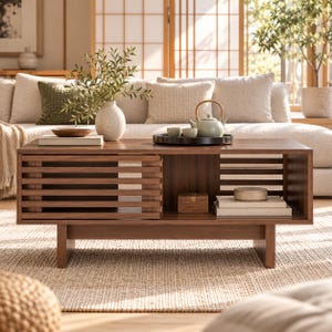 May include: A rectangular dark wood coffee table featuring a slatted sliding door on the left side and an open storage compartment on the right. The table has a low-profile design with sturdy block legs and a smooth, polished finish.