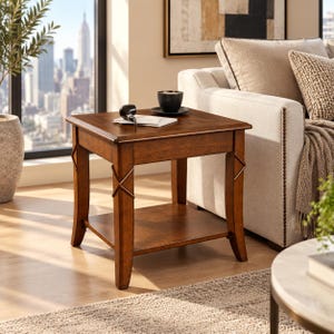 May include: A square wooden end table with a rich brown finish, featuring four legs with decorative X-shaped accents and a lower shelf. The tabletop holds a black mug on a saucer and a small stack of white paper with a black object on top.
