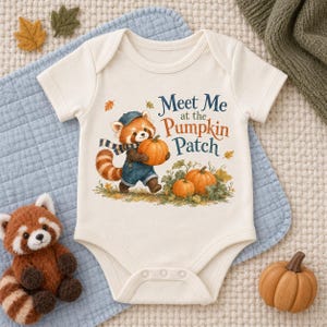 May include: A cream-colored short-sleeve baby bodysuit featuring a graphic of a red panda wearing a blue cap and scarf while holding a pumpkin. The text reads Meet Me at the Pumpkin Patch above two orange pumpkins and green foliage.