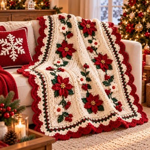 May include: A cream-colored crochet throw blanket featuring red poinsettia flowers, white blossoms, and green leaves, finished with a scalloped red border. A matching red square pillow with a white crocheted snowflake design is also visible.