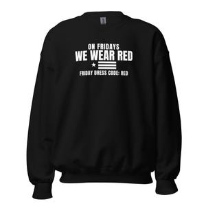 May include: A black long-sleeve crewneck sweatshirt featuring white text that reads ON FRIDAYS WE WEAR RED, followed by a small star and three horizontal lines, and the text FRIDAY DRESS CODE: RED printed in a clean, sans-serif font.