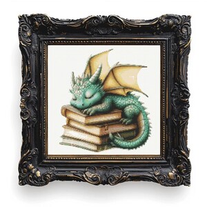 May include: A framed print featuring a sleeping green dragon with yellow wings atop a stack of books. The dragon is detailed with scales and horns. The frame is ornate, black with gold accents, and is set against a white background.