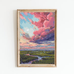 May include: Framed artwork featuring a pixelated landscape with a vibrant sunset. The sky is filled with pink and blue clouds, and the foreground depicts a green marsh with a river. The artwork is in a gold-colored frame.