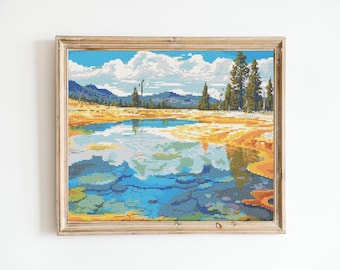 May include: Framed cross-stitch artwork depicting a scenic landscape with a blue lake reflecting the sky and clouds, surrounded by yellow and green hills and trees.