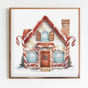 May include: A gingerbread house with candy cane trim, a red door with a wreath, and snow on the roof. The house is decorated with white frosting and red and white candy canes.
