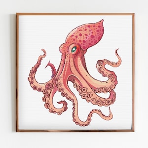 May include: A pink octopus with green eyes and a spotted body is shown in a white frame. The octopus has eight tentacles with suckers.