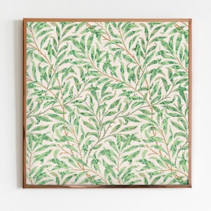 May include: A framed print with a repeating pattern of green leaves and branches on a white background. The frame is a copper color.