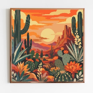 May include: A square pixel art print featuring a desert landscape at sunset. The scene includes tall saguaro cacti, prickly pear cacti with orange blossoms, and rocky formations under a bright yellow sun and vibrant orange and red sky.