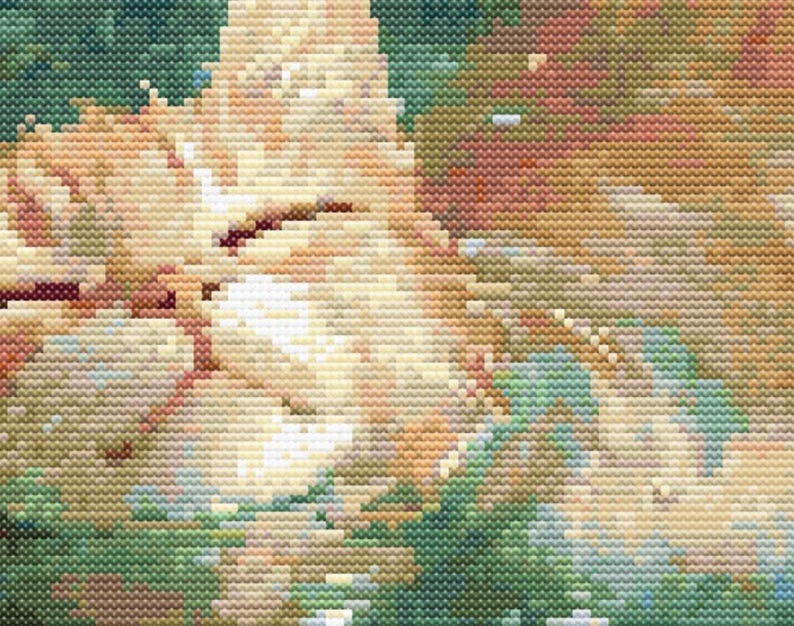 May include: A close-up of a cross-stitch pattern depicting a cat's face. The cat's fur is a light orange color, and the background is a mix of green and brown.