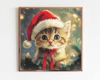 May include: A cute brown tabby kitten wearing a red Santa hat with white trim. The kitten has big green eyes and is looking directly at the viewer. The background is a blurry green and gold.