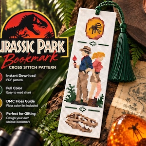 May include: A rectangular white bookmark featuring a cross-stitch pattern of two figures standing back-to-back, a dinosaur fossil, and an amber-coloured oval icon. The bookmark is finished with a dark green tassel attached at the top.