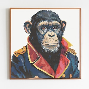 May include: A framed cross-stitch portrait of a chimpanzee wearing a military-style jacket. The jacket is navy blue with red accents and gold epaulettes. The chimpanzee has a serious expression.