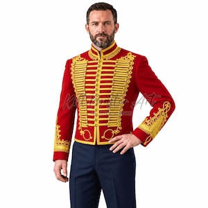 May include: A vibrant red military-style jacket featuring intricate gold braided cord detailing, a high mandarin collar, and rows of gold buttons down the front. The cuffs and chest are adorned with elaborate gold embroidery patterns.