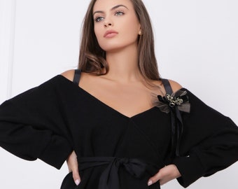 Designer Black Knitted Cashmere Blouse with Off-The-Shoulder Sleeves and a Bee Brooch