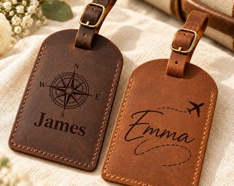 Puede incluir: Dos etiquetas de equipaje rectangulares de cuero marrón con correas ajustables y hebillas de tono latón. Una etiqueta presenta un grabado de rosa de los vientos y el nombre James. La otra muestra una trayectoria de vuelo punteada, un icono de avión y el nombre Emma.