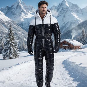 May include: A full-body, insulated, quilted ski suit featuring a glossy black finish on the lower section and sleeves, contrasted by a white upper chest and hood. The garment includes a front zip, a waist belt, and black gloves.
