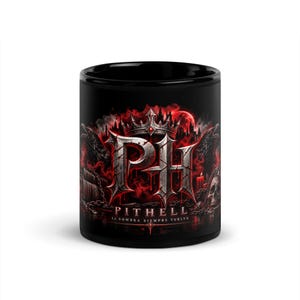 May include: A black ceramic mug featuring a graphic design with the letters PH in a metallic, weathered font topped by a crown. The artwork includes red smoke, ravens, a skull, and the text PITHELL LA SOMBRA SIEMPRE VUELVE in a dark, gothic style.