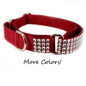 May include: A red dog collar with silver-colored metal hardware and a decorative band of sparkling rhinestones. The text "More Colors!" is written below the collar.
