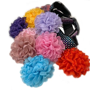 May include: Assortment of colorful fabric flower embellishments in various shades of pink, purple, blue, yellow, and orange. The flowers are made of soft, ruffled fabric and are perfect for adding a touch of whimsy to any project.