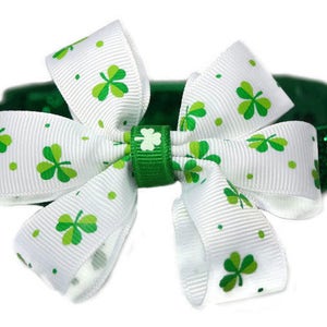 May include: A green glitter dog collar with a white bow featuring green shamrock print.