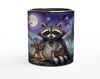 May include: A ceramic mug featuring a graphic of a raccoon dressed as a vampire in a cape, holding a brown book and a lit lantern with a small bat perched on top. The background shows a full moon, a dark forest, and a church silhouette.