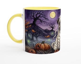 May include: A ceramic mug with a bright yellow handle and interior, featuring a wrap-around illustration of a pug dressed as a mummy sitting in a dark forest with orange pumpkins, bare trees, and a full moon against a purple night sky.