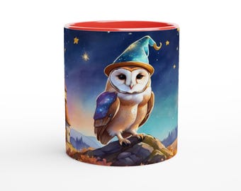 May include: A ceramic mug with a red interior and rim, featuring a wrap-around illustration of a barn owl wearing a blue wizard hat. The owl is perched on a rock against a night sky filled with stars, with a distant building visible.