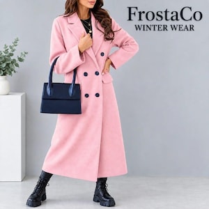 May include: A long, light pink double-breasted coat with dark buttons, worn over a black top. The coat features a notched collar and long sleeves. A dark blue structured handbag is held at the side. Text reads FrostaCo WINTER WEAR.