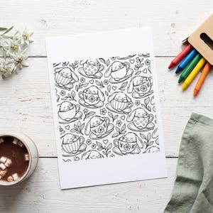 May include: A black and white coloring page featuring a repeating pattern of small rabbits sleeping inside various teacups, surrounded by floral motifs, leaves, and small hearts, printed on a rectangular sheet of white paper.