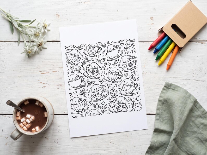 May include: A black and white coloring page featuring a repeating pattern of small rabbits sleeping inside various teacups, surrounded by floral motifs, leaves, and small hearts, printed on a rectangular sheet of white paper.