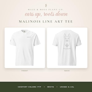 May include: A white short-sleeve t-shirt featuring a small black text graphic on the front chest that reads EARS UP. The back displays a black line art illustration of a Malinois dog head with roots at the base and the text EARS UP, ROOTS DOWN.