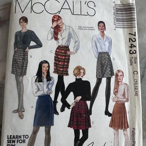 May include: McCall's 7243 sewing pattern envelope featuring illustrations of six skirt styles labeled A through E. The cover displays various skirt designs including plaid, solid, and patterned fabrics, with the text Learn to Sew for Fun and Fashion Basics.