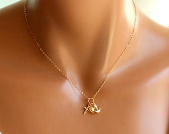 May include: A gold chain necklace with a small cross, heart, and anchor charm.
