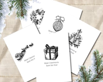 May include: A set of five white greeting cards featuring black ink illustrations of a Christmas wreath, an ornate ornament, two bells, a gift box with a bow, and a sleigh with reindeer, all with the text Merry Christmas & Happy New Year.